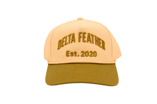 Green bill with a cream hat and the words "Delta Feather" and "EST. 2020" 