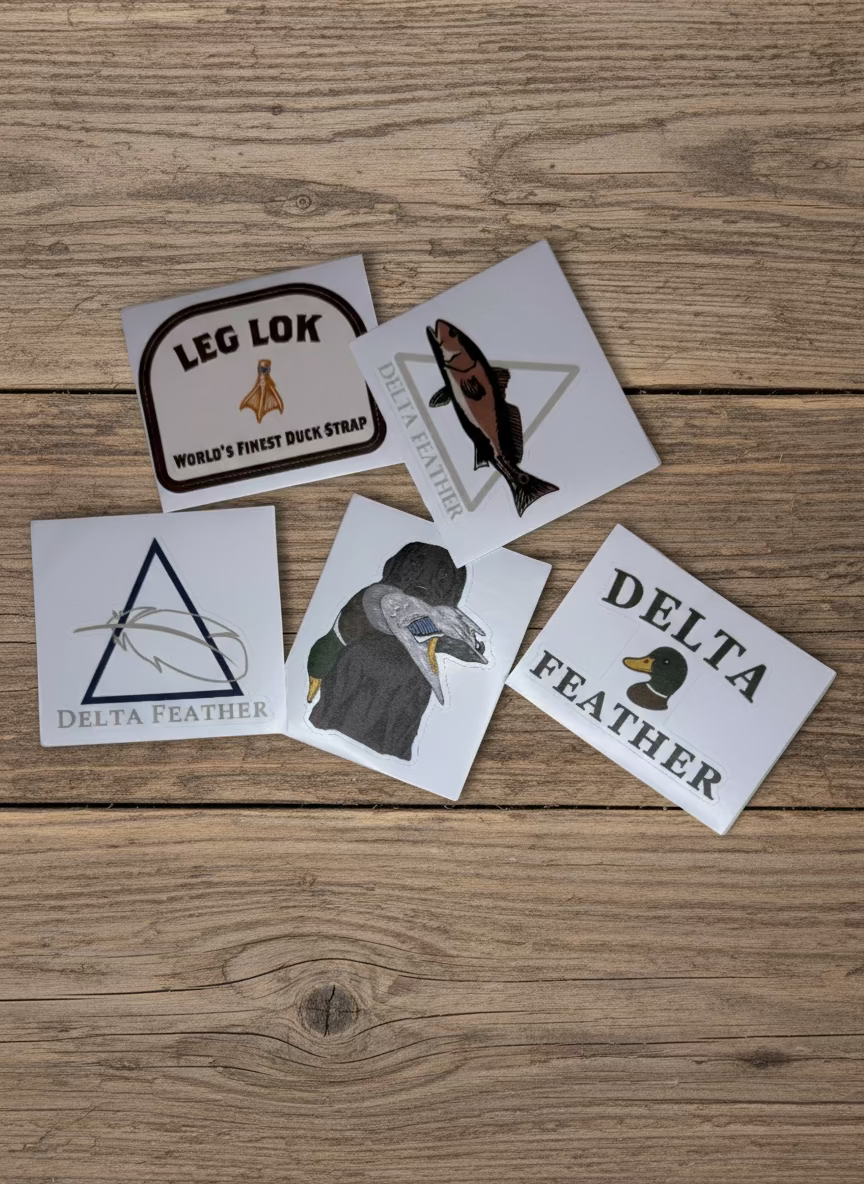 Five stickers with various designs and text on a light surface