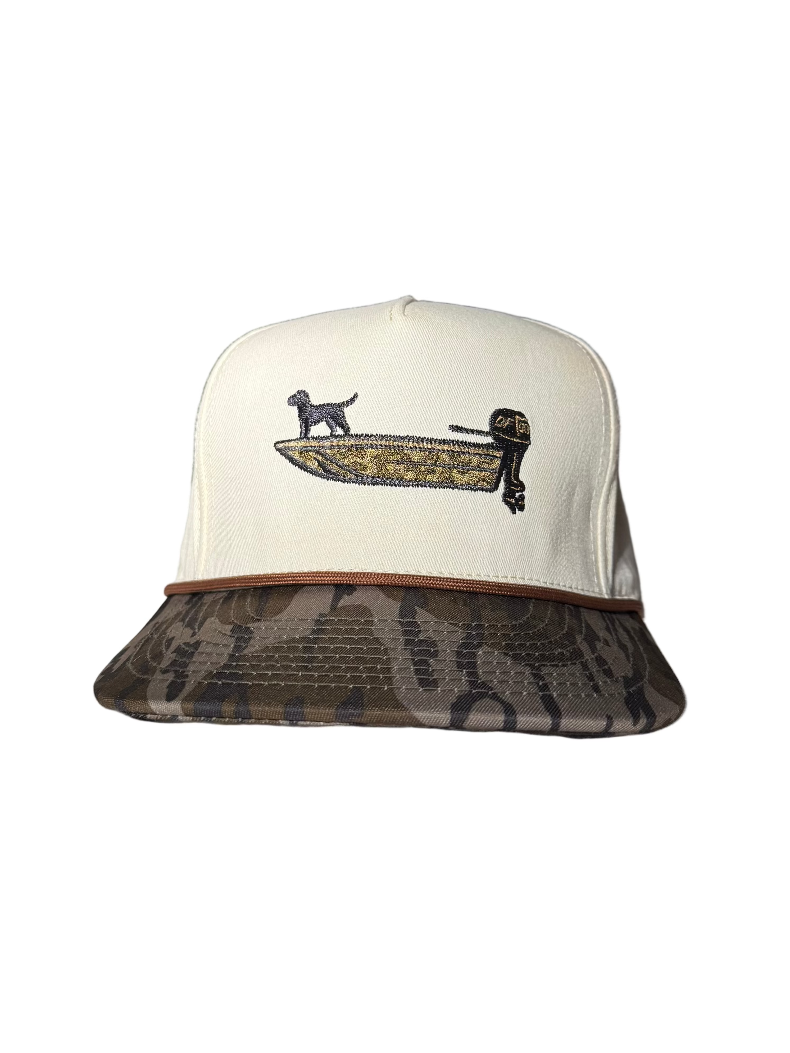 A white cap with bottomland bill with a duck boat on it 