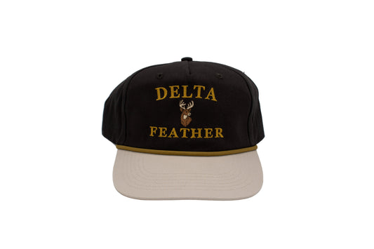 The words Delta Feather with a deer in the middle. On a black hat with a tan bill. 